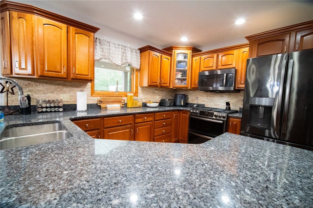well organized kitchen with maple cabinets