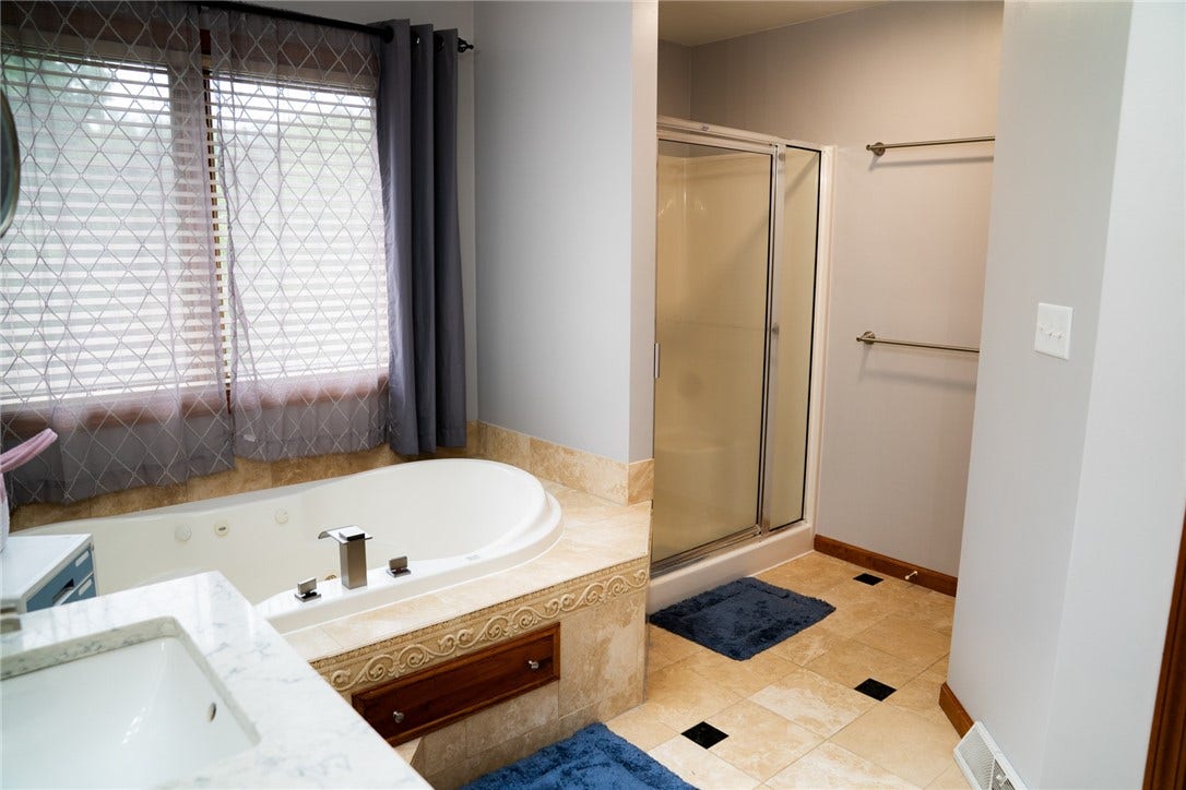 Jetted tub with stand alone shower in primary