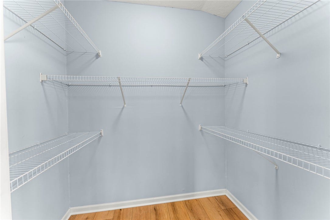 Main level bedroom suite ideal for in~law or guest space, walk in closet