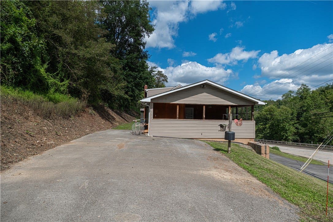 This is the back of the house.  You can drive up the steep driveway and enter the house through the covered porch.