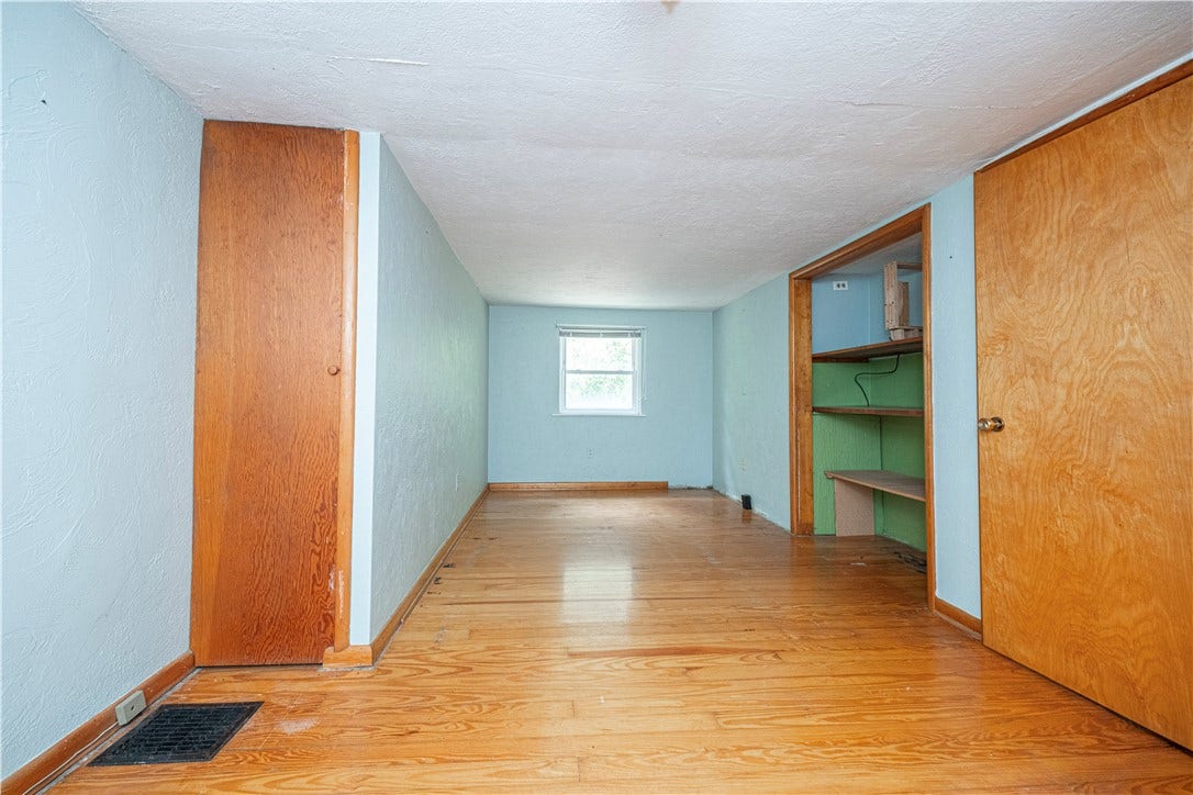 Second floor bedroom. It measures 18'9" x8'8".  Hardwood floors, a window, and great storage make this a great space.
