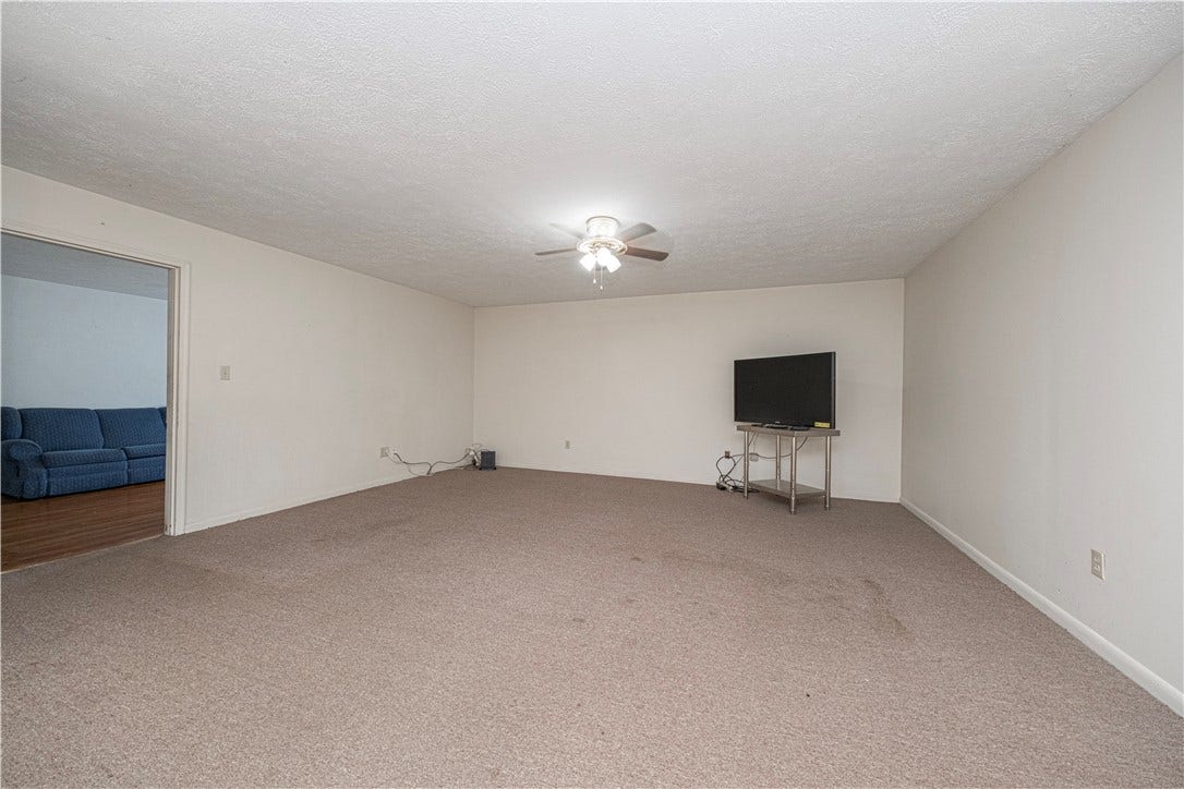 This large room sits between the side porch and the living room.
