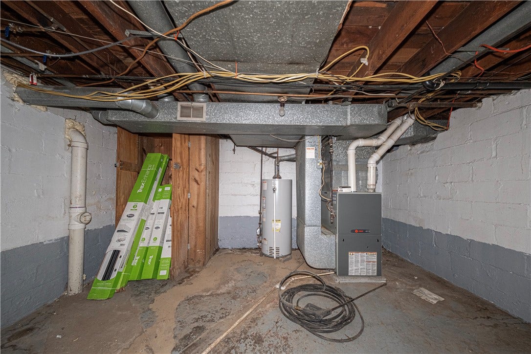 Furnace room.  Both furnace & water tank were installed in 2014, according to the stickers on the appliances.  There's plenty of room in here for storage.