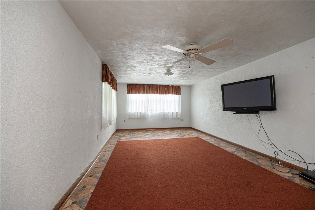 The family room is where you will enter from the side door on the right.