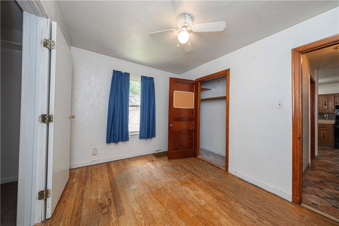 The first floor bedroom measures 11'6" x9'9" and has a walk-in closet as well as a ceiling fan.