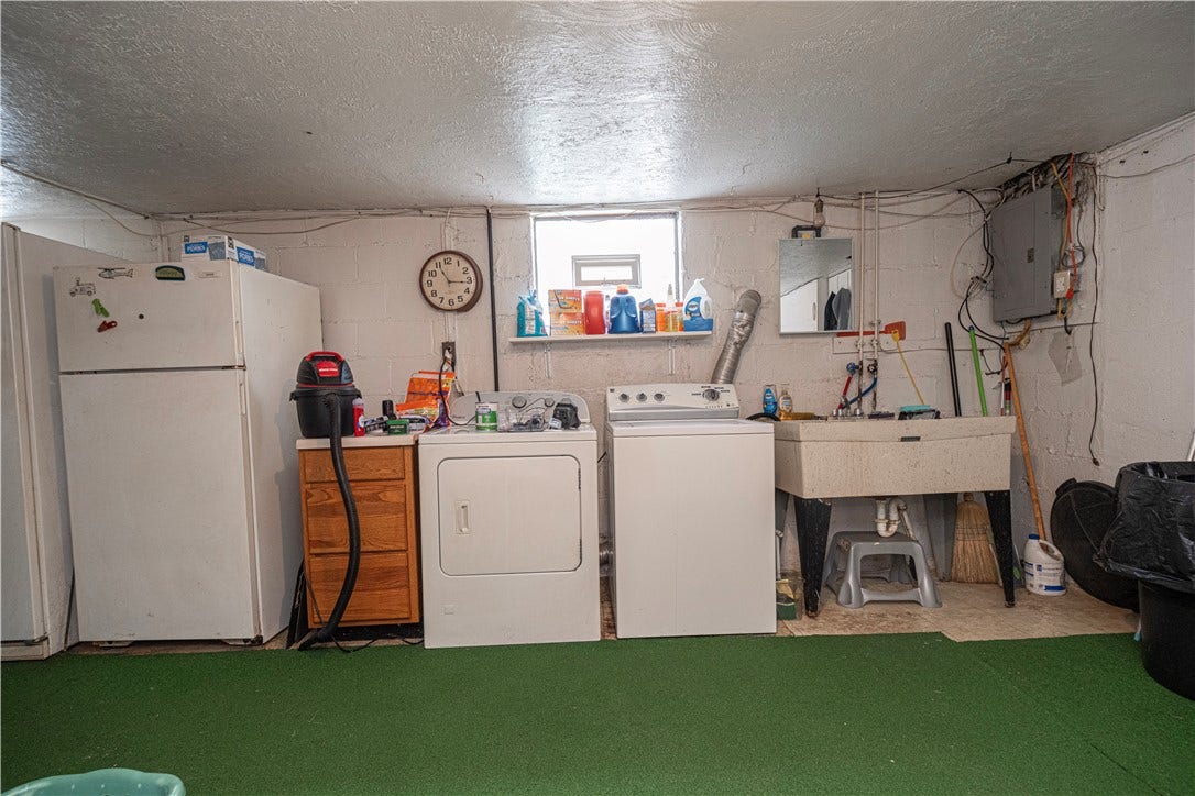 The laundry is in the basement.  Seller will be removing the washer, dryer, and refrigerator.   There's a 100 amp electric panel near the rinse tub.