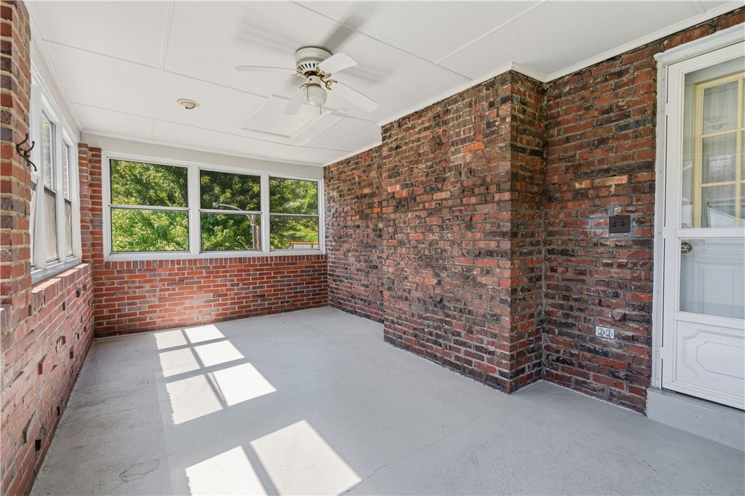 The enclosed porch located off of the living room comes with both windows and screens for nearly year round use.