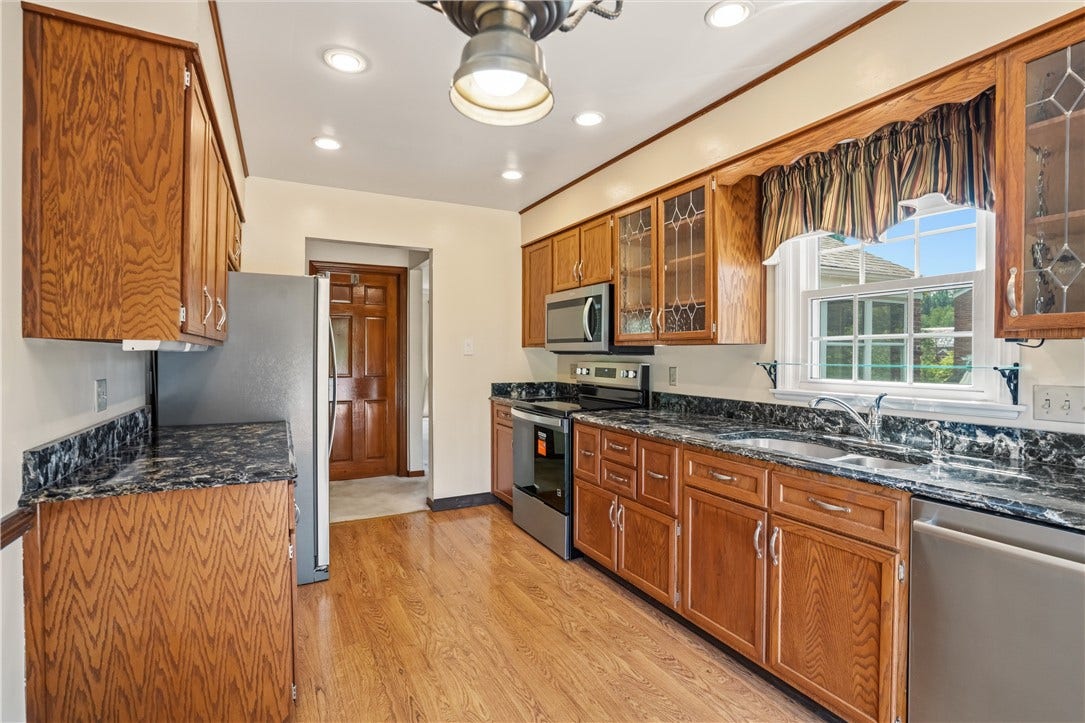 Granite counters and new stainless steel appliances complete the eat in kitchen.
