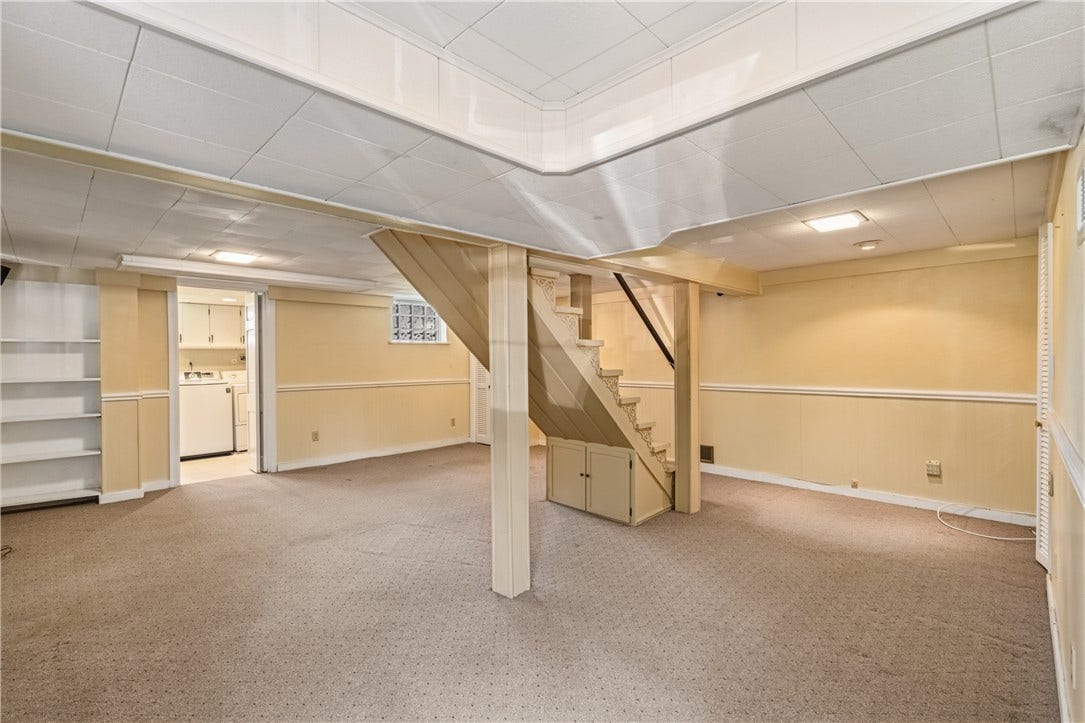 Finished game room with separate laundry area.