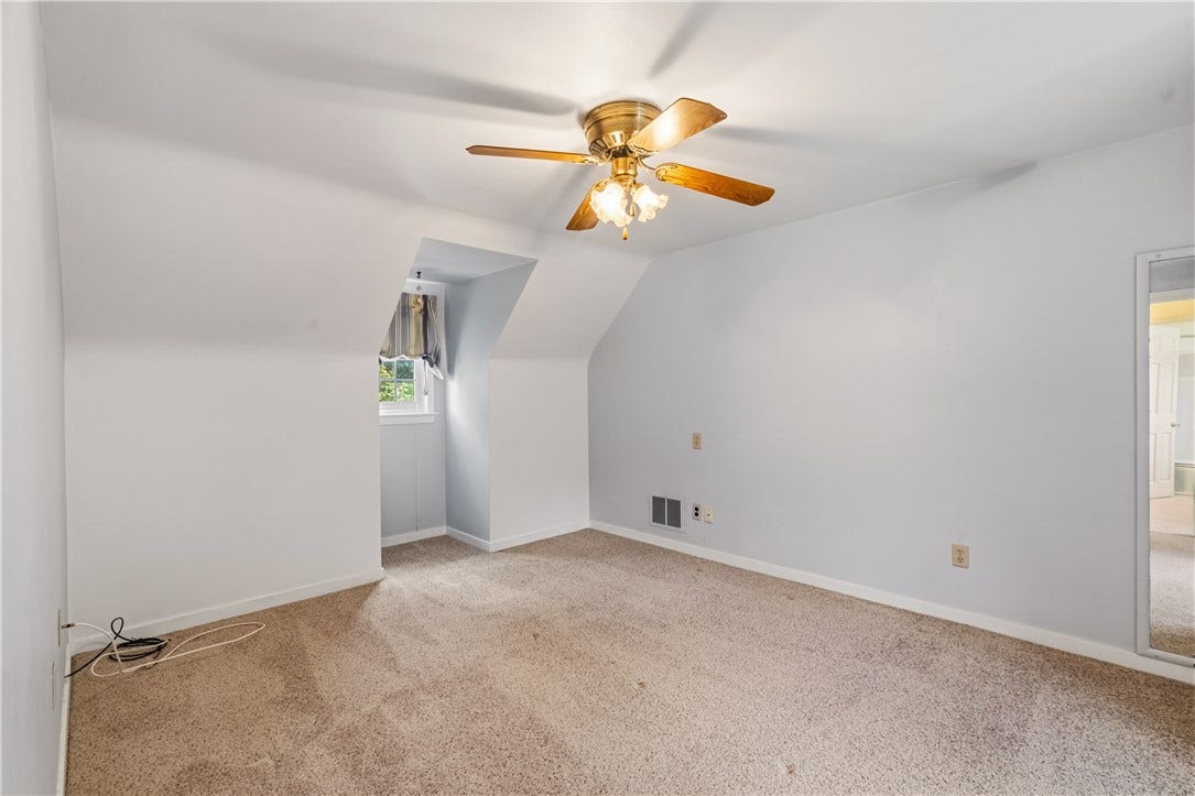 Upstairs bedroom with hardwood under the carpet.