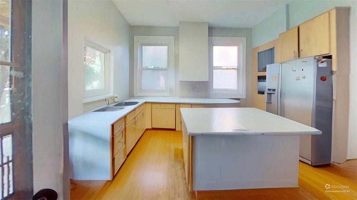 5546 Hays St, Pittsburgh, PA 15206 Wide view of kitchen. Back door opens to the full width porch, with streaming sunlight through two large skylights.