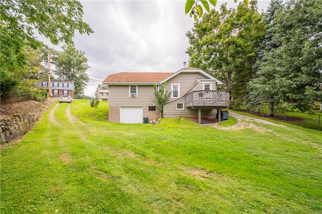 unpaved driveways on either side for plenty of off street parking.