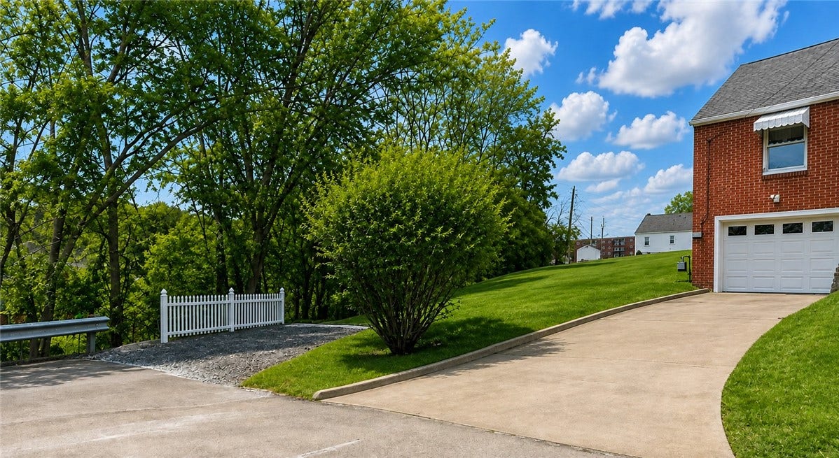 Integral garage, driveway parking, and an additional spot to the side of the yard