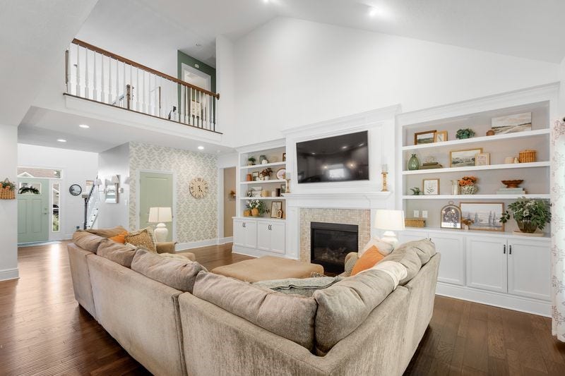 Gas log fireplace flanked by built-in bookcases.
