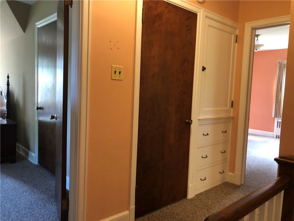 Hallway has built in  cupboard with drawers
