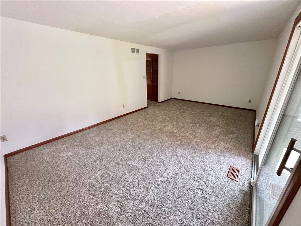 family room with new carpet that has never been lived on