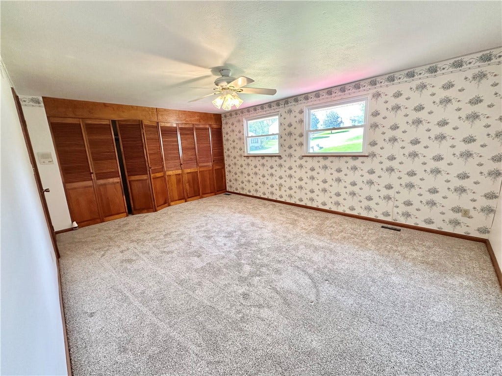 primary bedroom with a wall of cabinets