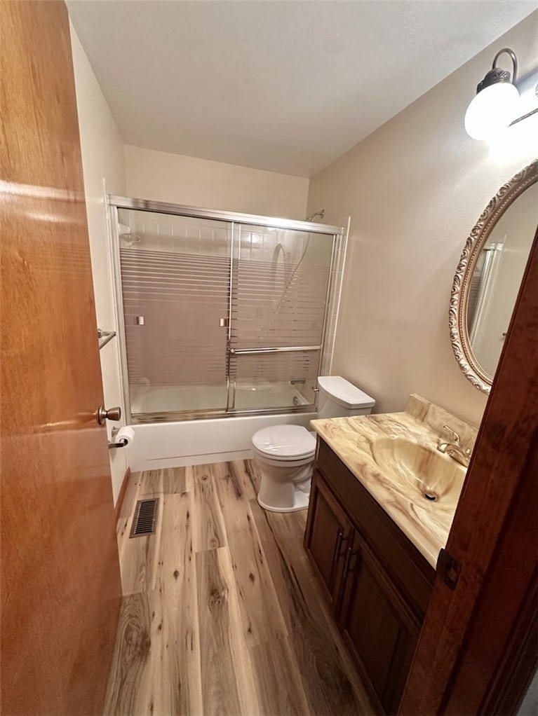 full bath with wallpaper removed