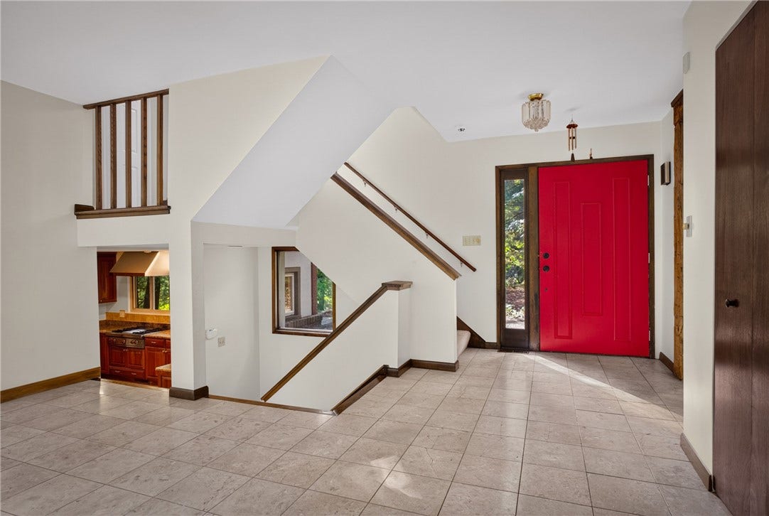 Soaring ceilings and abundant natural light create a dramatic welcome.