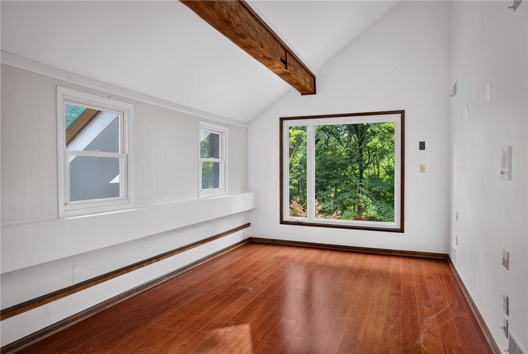 High beamed ceilings create an open and dramatic retreat.