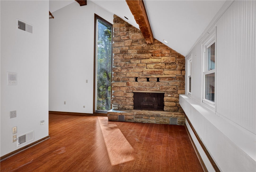 The upper-level bonus suite offers exceptional flexibility.  Wood floors and a stone fireplace add character.