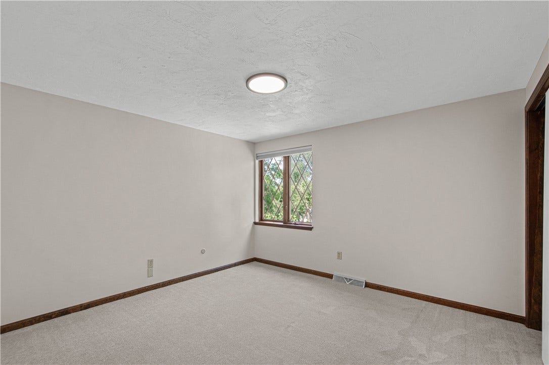 A bright, versatile secondary bedroom offers comfortable space for family or guests.