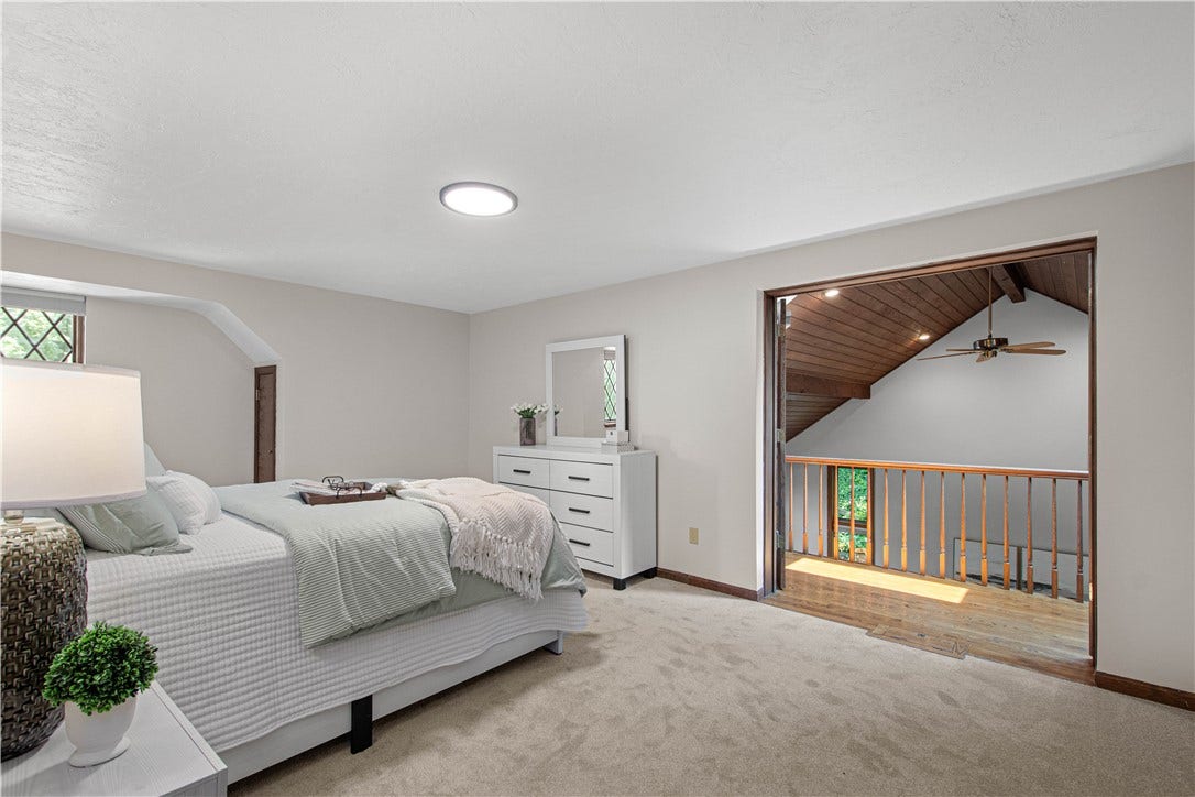 A second view highlights the suite's connection to the home's distinctive two-story architecture.