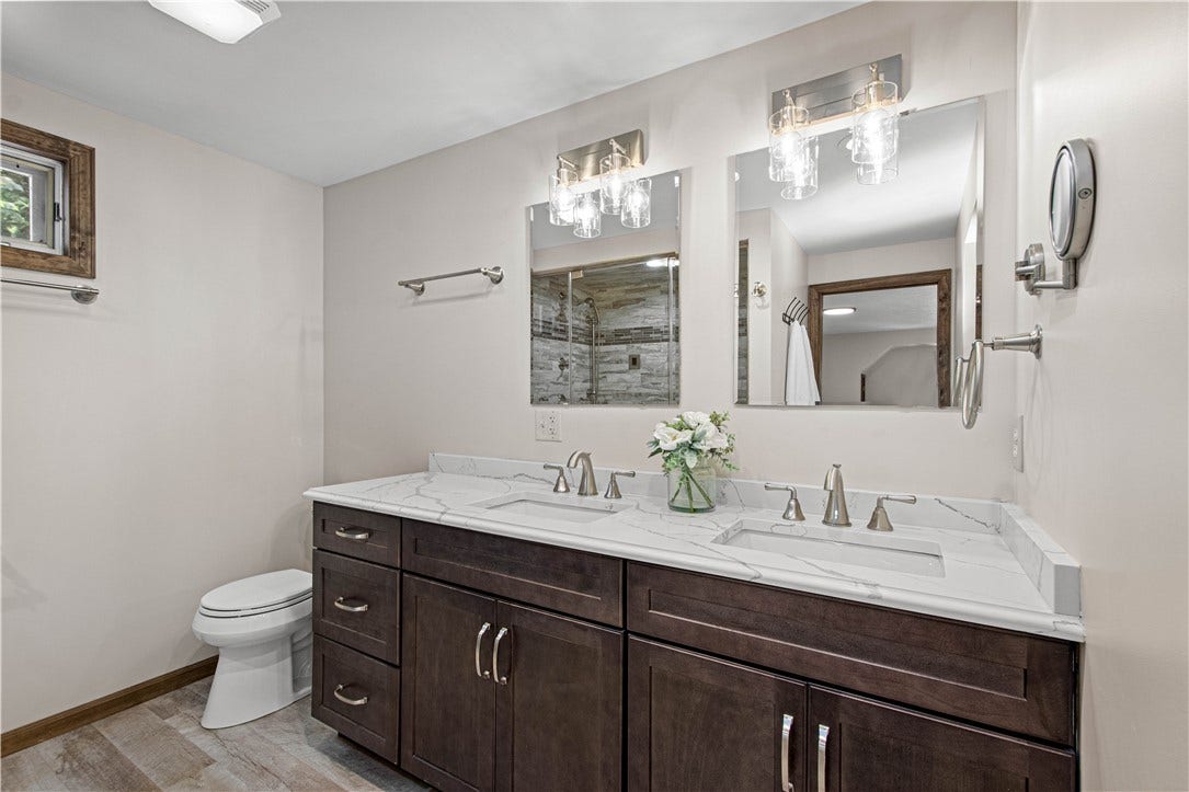 A beautifully updated double vanity creates a polished, spa-inspired start and finish to each day.