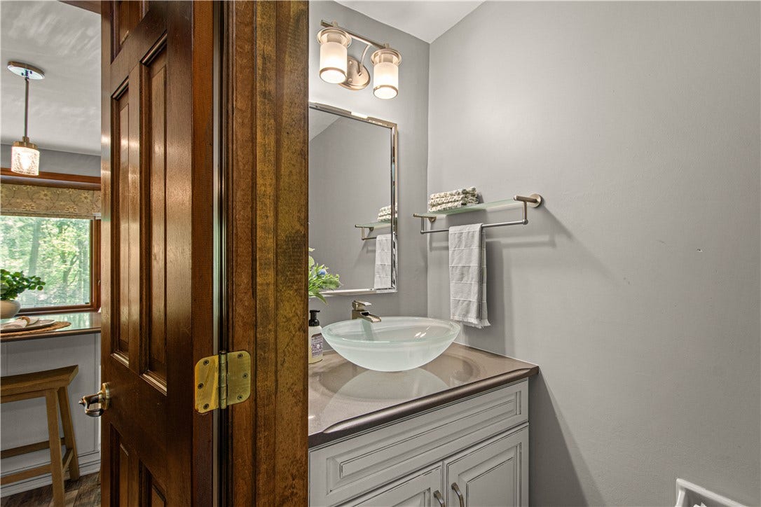 An updated main-level powder room pairs modern finishes with the home's warm, classic character.