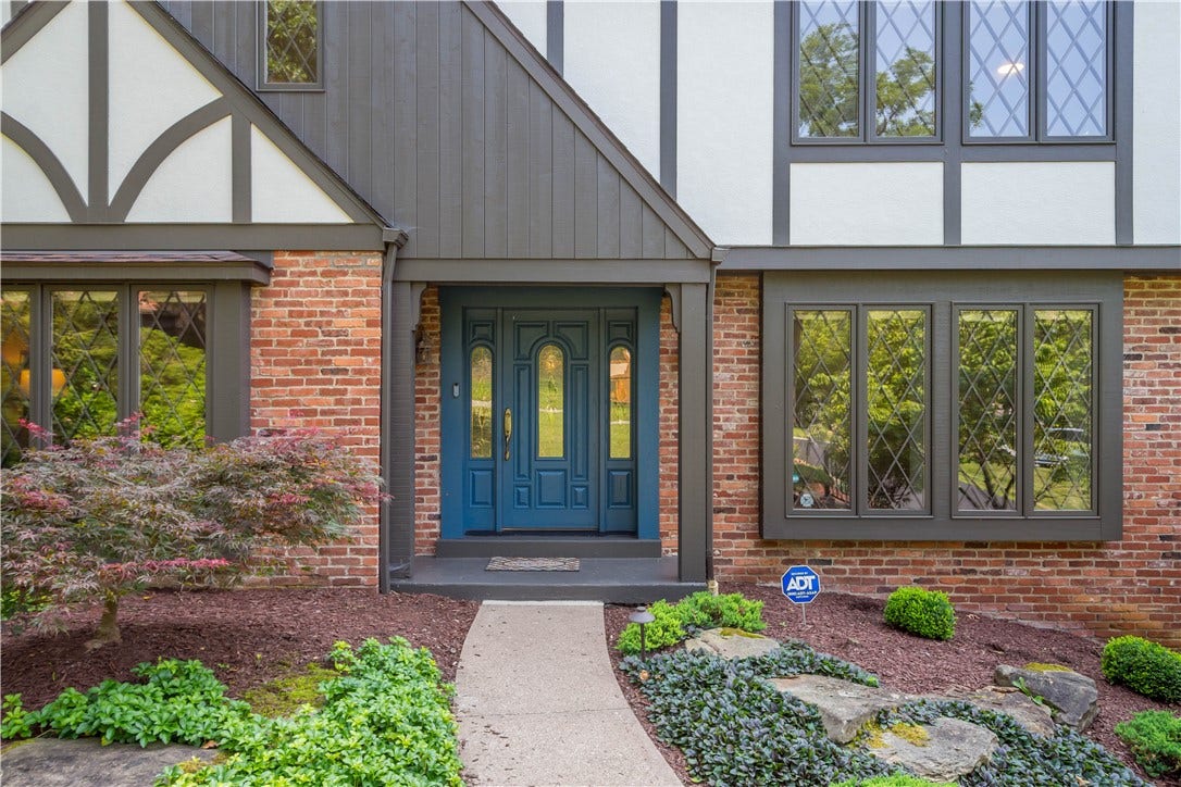 Distinctive Tudor details and a welcoming entry hint at the character found throughout the home.