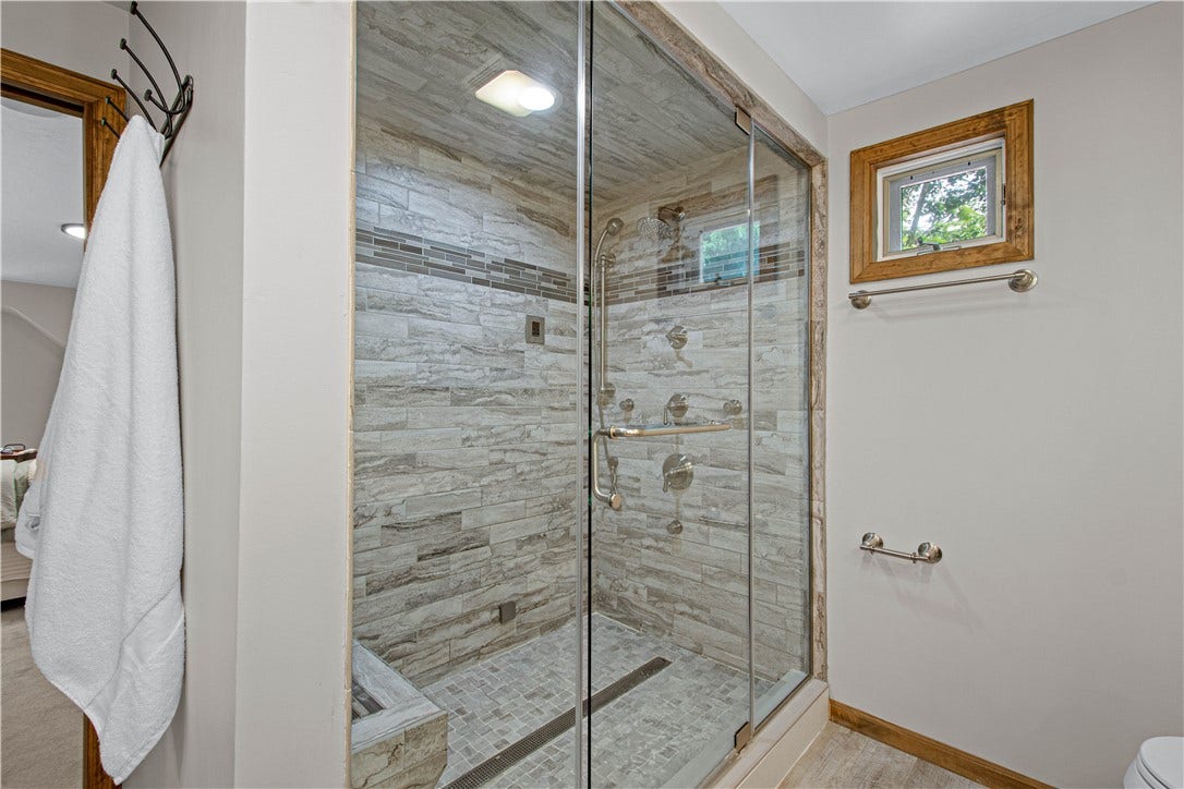 The custom tiled steam shower transforms the primary bath into a relaxing at-home retreat.