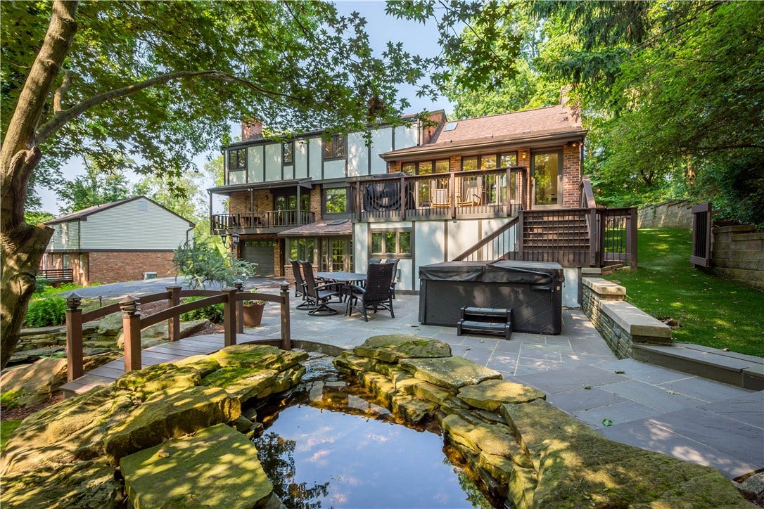 A resort-like backyard designed for lingering outdoors, with multiple spaces to relax, gather, and entertain.