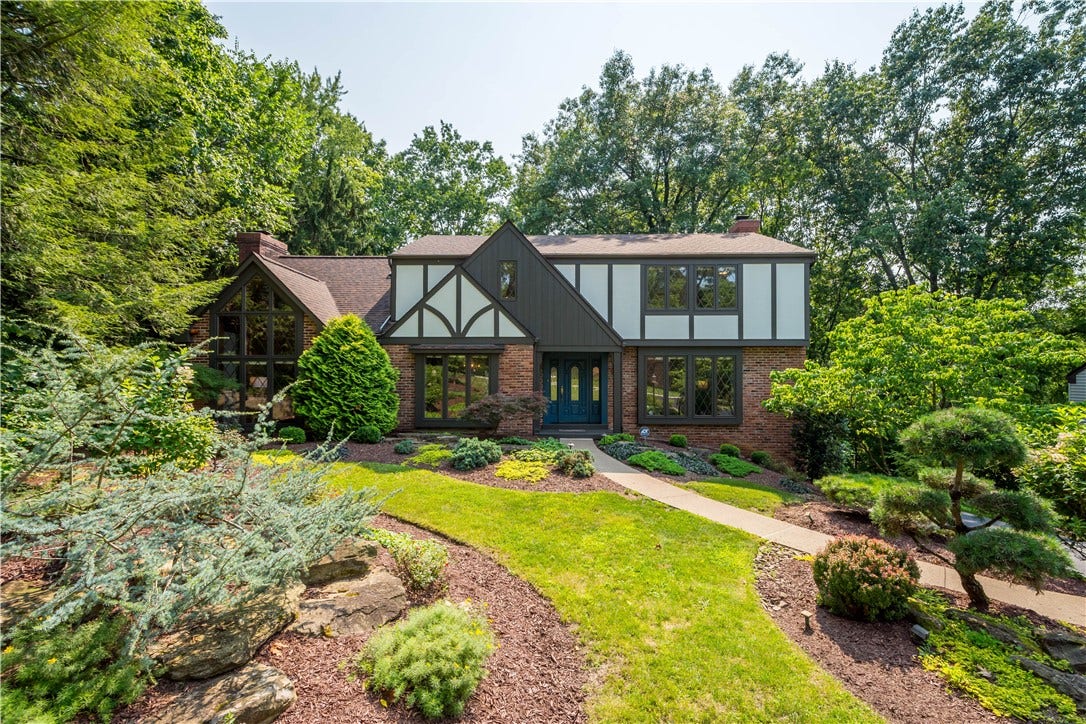 A private, beautifully landscaped setting welcomes you home with winding pathways.