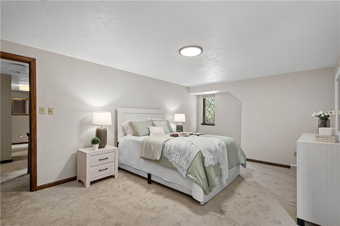 A spacious primary retreat with soft neutral finishes and plenty of room to unwind at the end of the day.