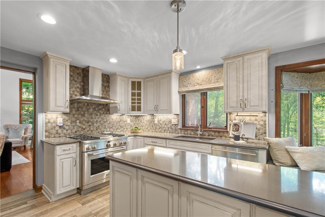 Beautifully updated for modern living with quartz surfaces, abundant cabinetry, and a substantial island made for mornings on the go.
