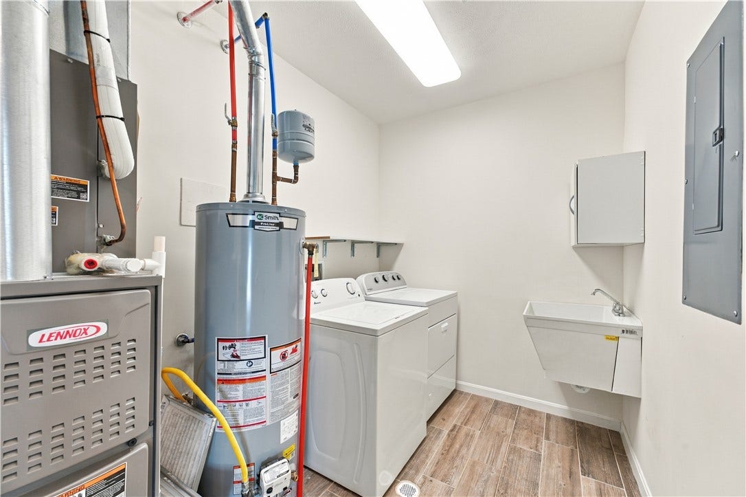 Spacious Laundry/Utility Room.  The Washer and Dryer will Convey