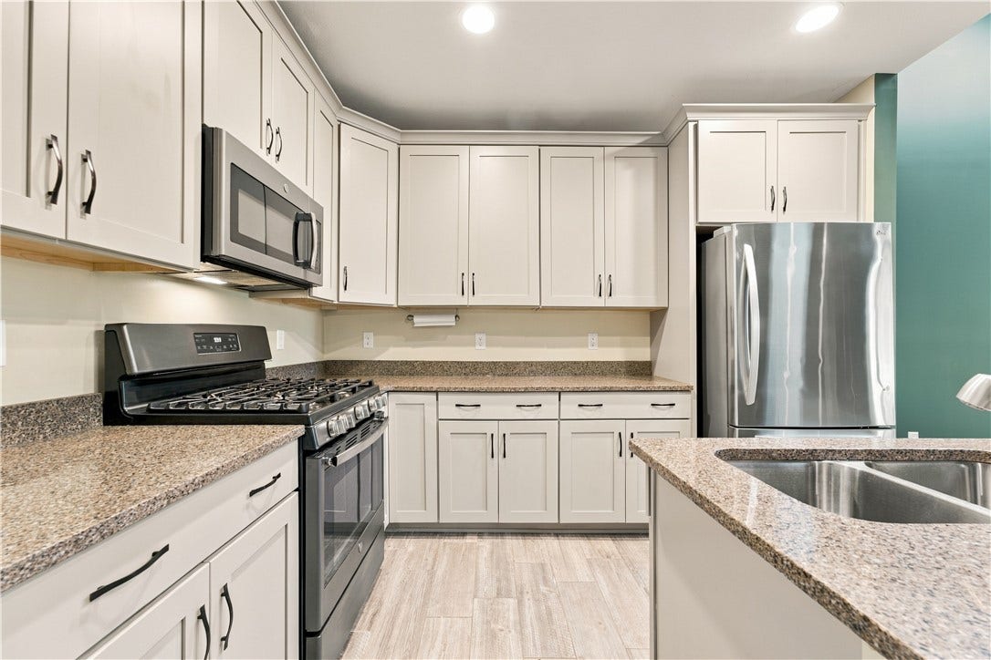 The Kitchen Features Recessed Lighting and a Center Island