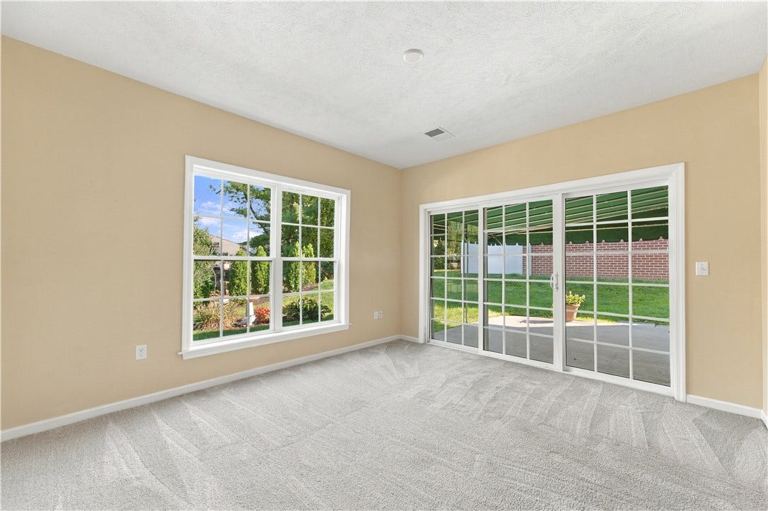 The Sun Room Features a 9' Sliding Door to the Rear Patio