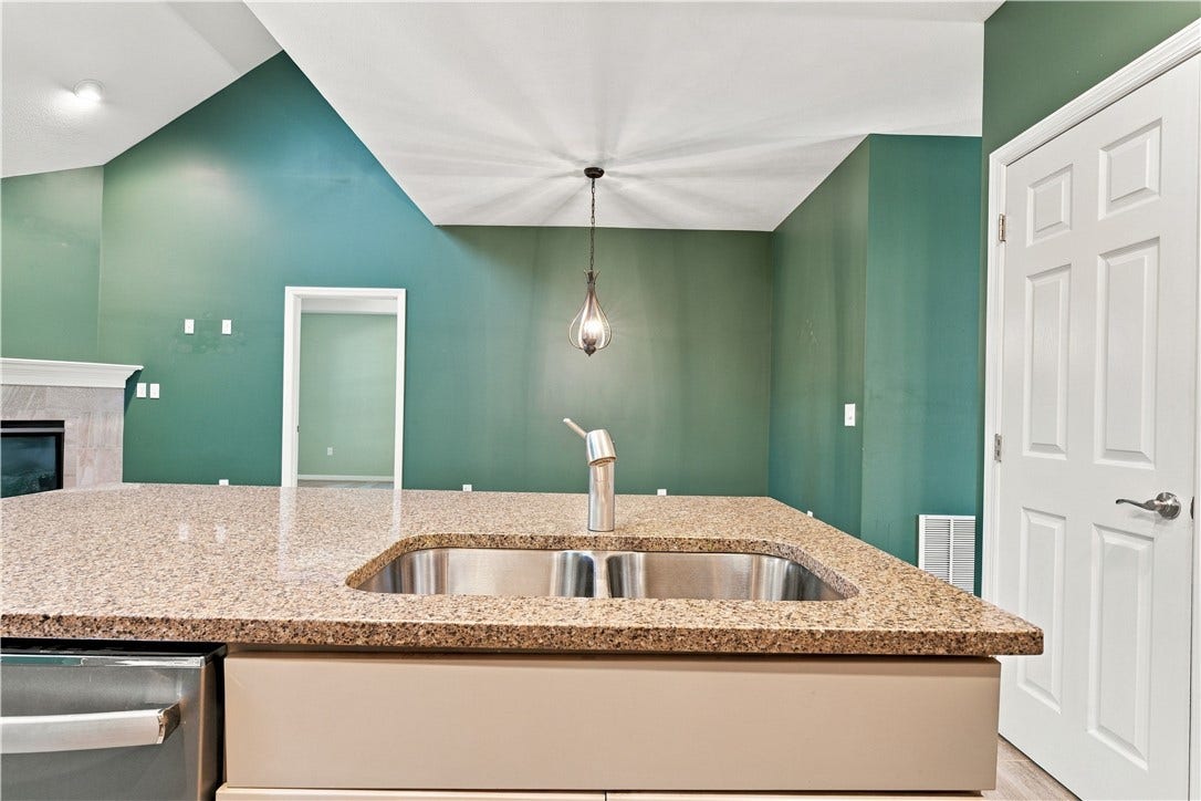 The Sink is Within the Island and the Door to the Rt. is for the Pantry