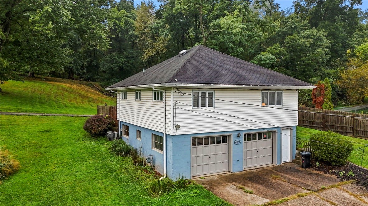Rear of home featuring a two ca garage.