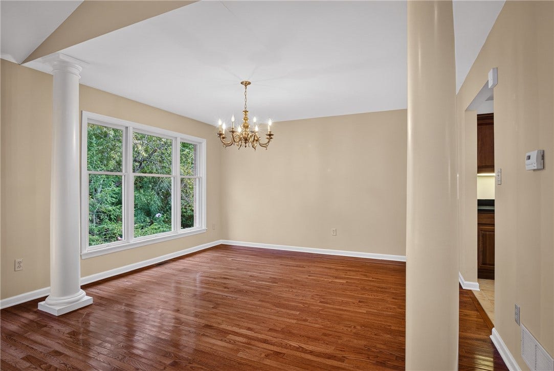 OPEN DINING SPACE WITH HARDWOOD FLOORS AND ROOM FOR ENTERTAINING.