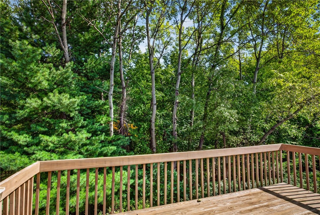 ENJOY PEACEFUL WOODED VIEWS FROM THE SPACIOUS REAR DECK.