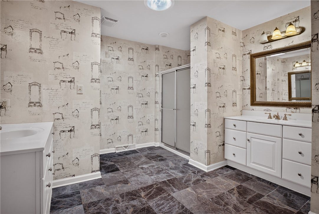 DUAL VANITIES PROVIDE GENEROUS STORAGE AND PERSONAL SPACE.