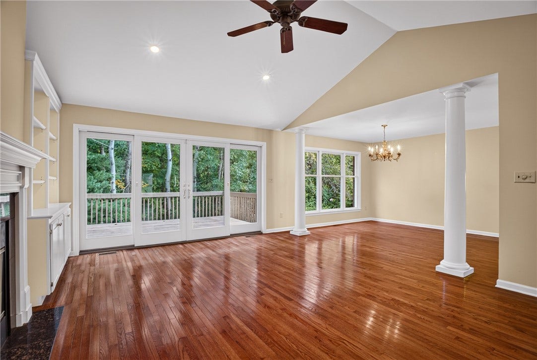 GLASS DOORS PROVIDE EASY ACCESS TO THE EXPANSIVE REAR DECK.