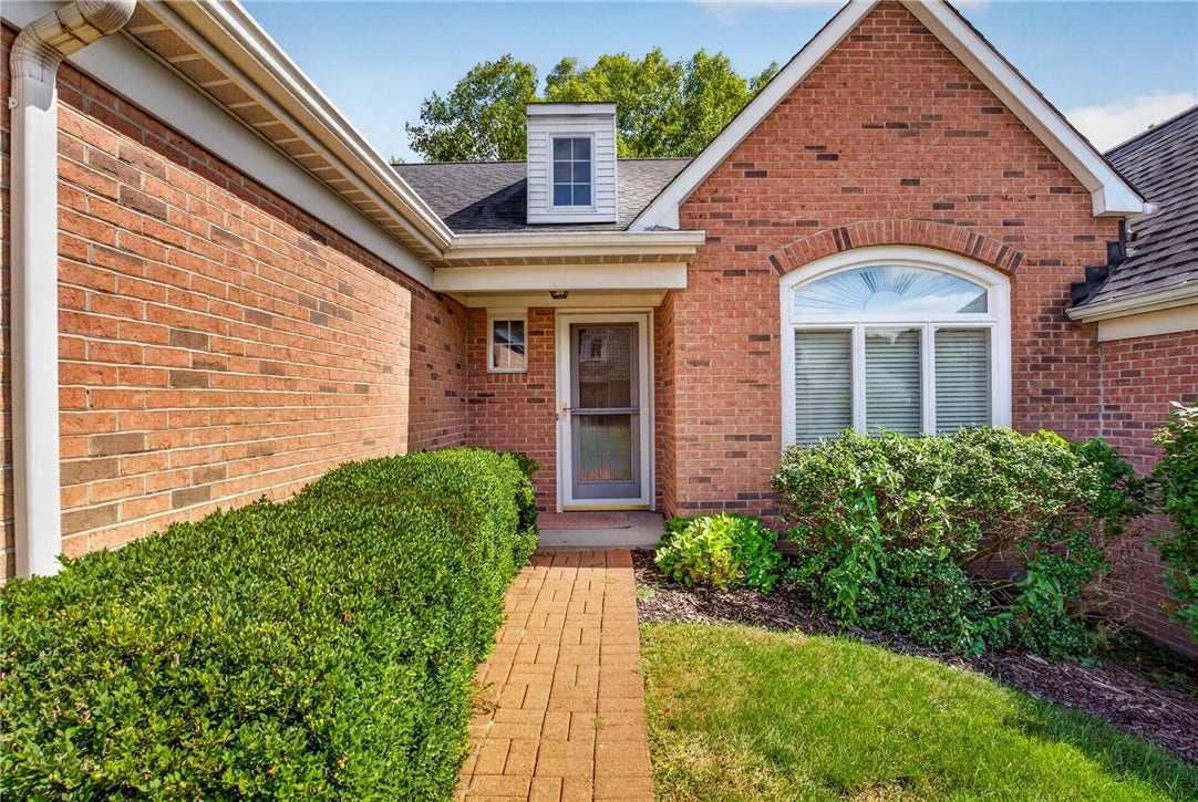 BRICK TOWNHOME WITH ATTACHED TWO CAR GARAGE.