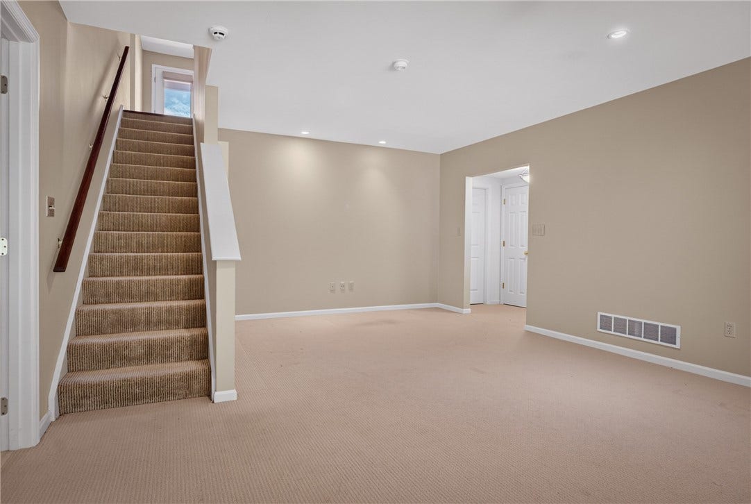 LARGE LOWER LEVEL GAME ROOM OFFERS FLEXIBLE ADDITIONAL LIVING SPACE.