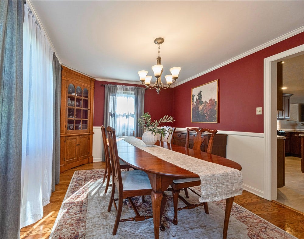 Dining room with a charming built in corner cabinet and plenty of space for gathering.