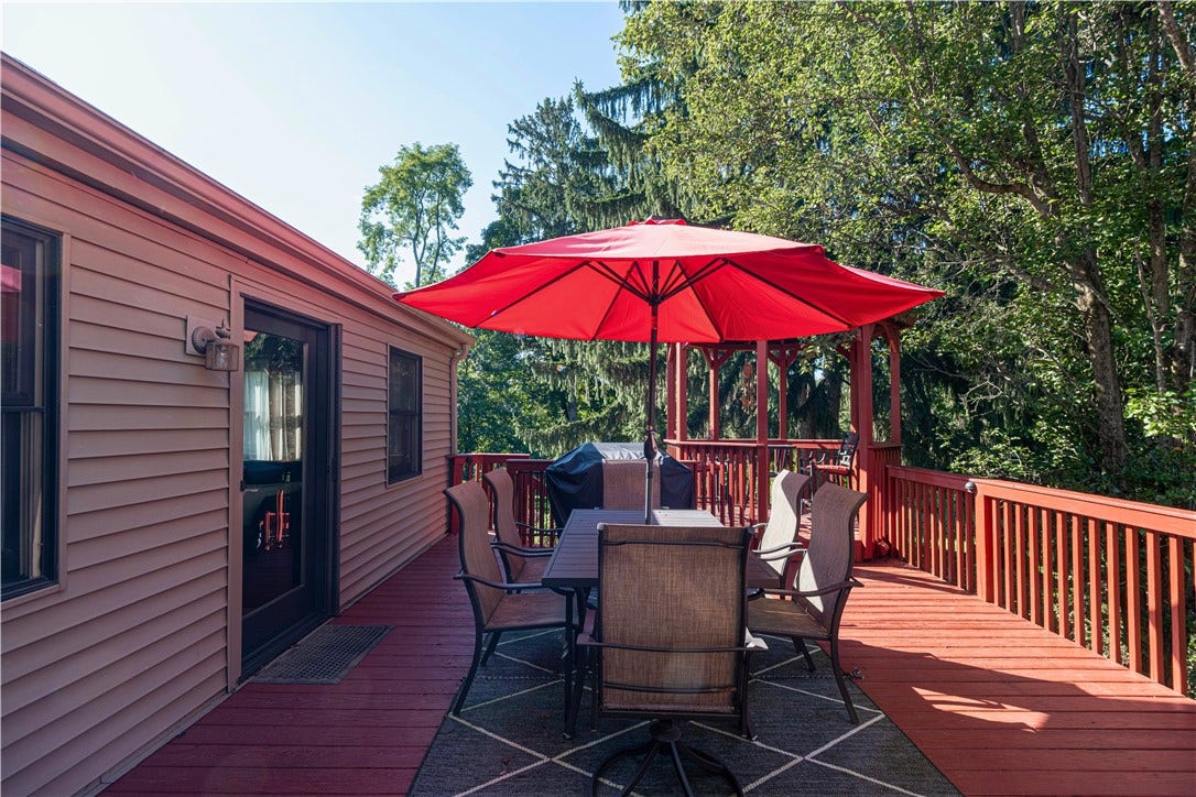 Spacious deck with direct access from both the living room and family room, plus stairs leading to the backyard.