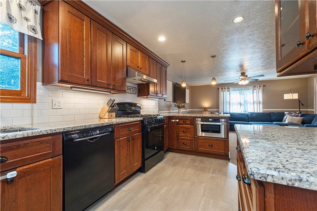 Updated kitchen with granite countertops, microwave drawer, and an open layout to the family room addition.