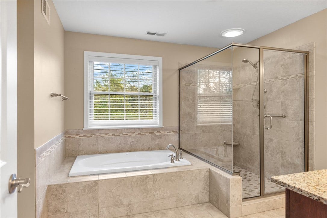 Jetted Tub and tiled walk in shower